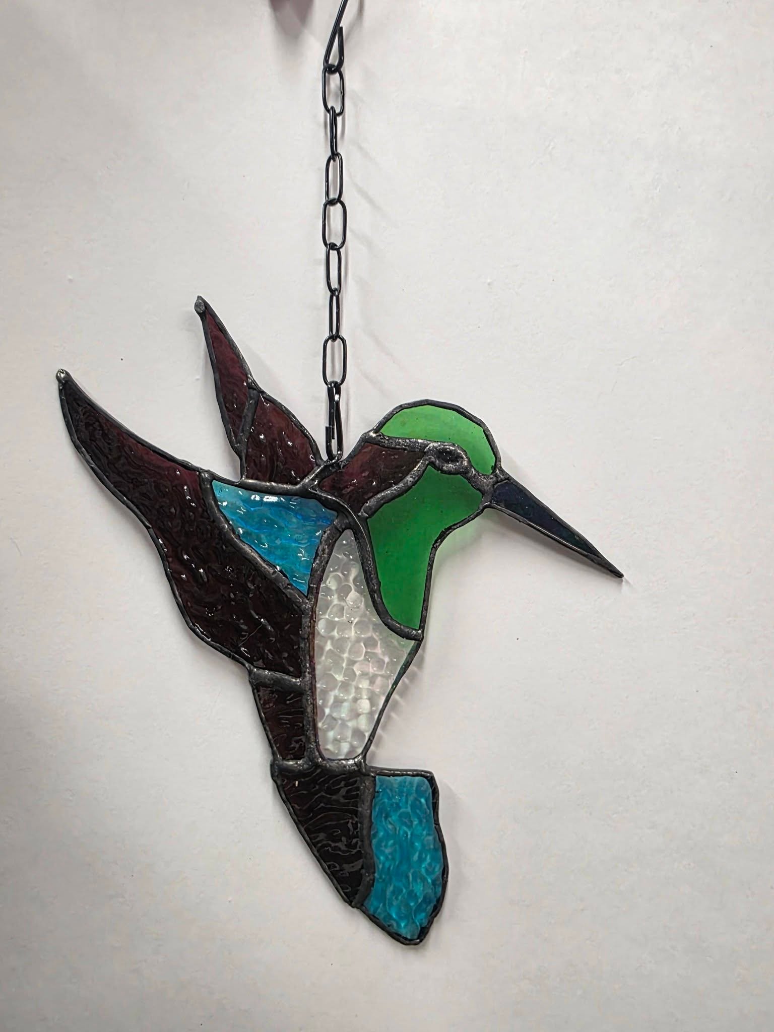 Stained glass hummingbird suncatcher, wine and green tones