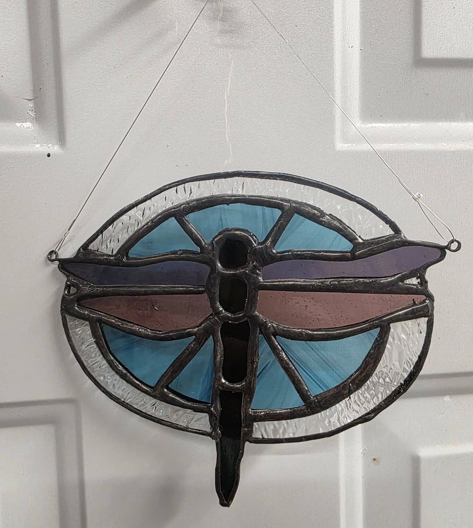 Stained glass dragonfly suncatcher in the studio