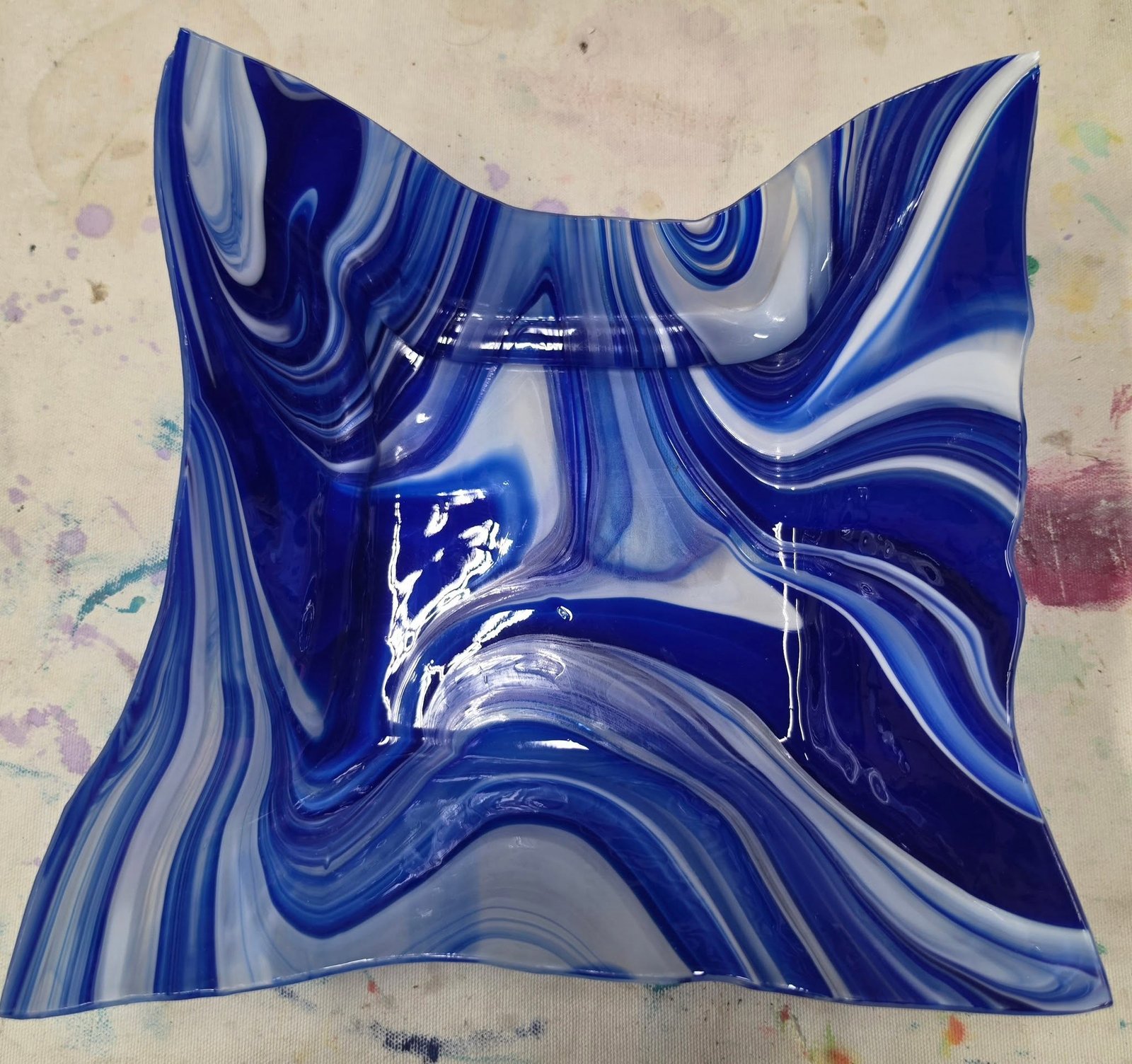 Finished glass pieces and slumping molds on display